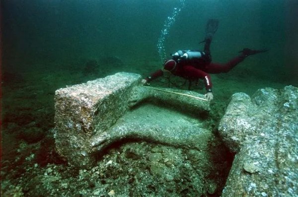 A diver measures underwater ruins